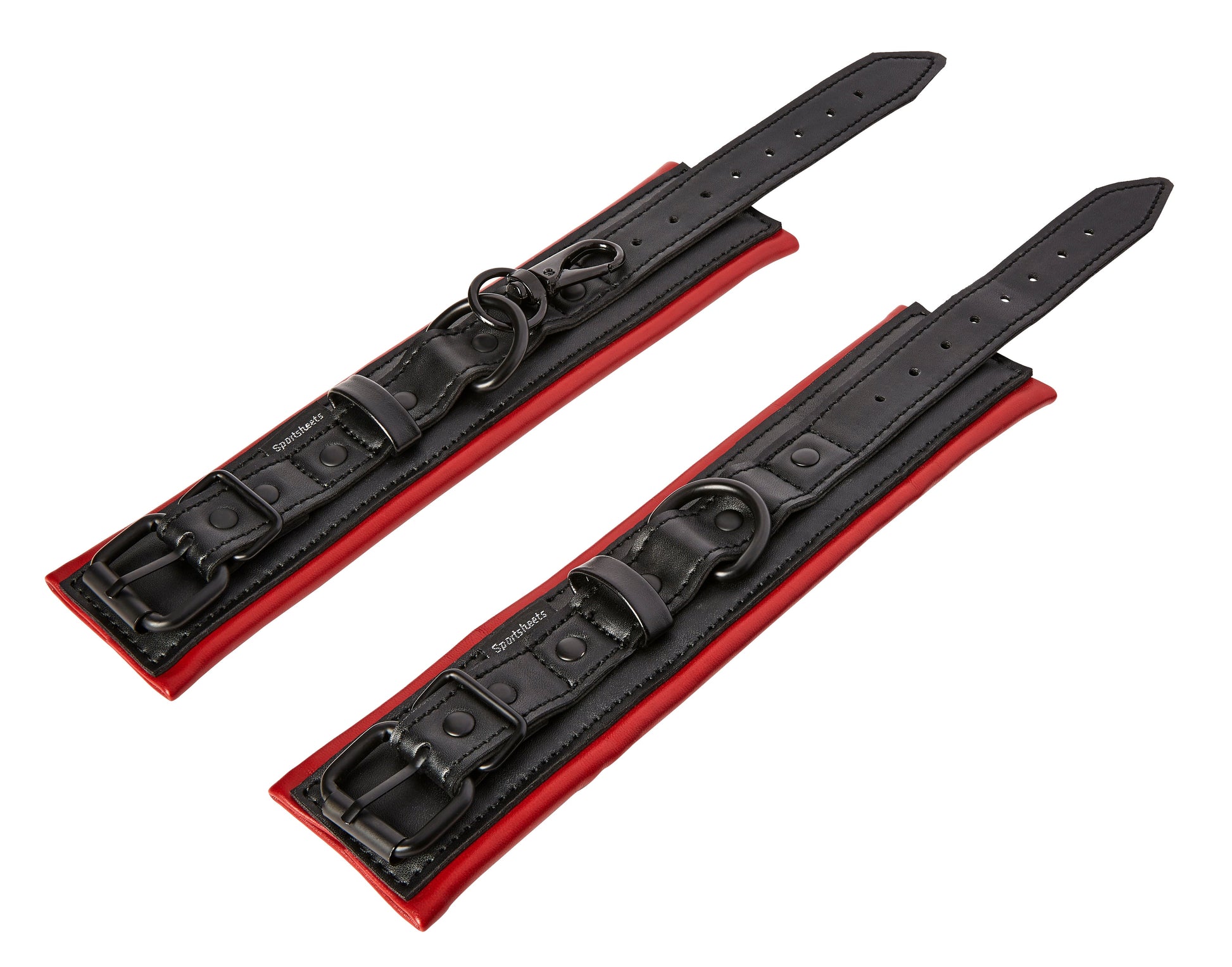 Adjustable vegan leather wrist cuffs with red lining and black hardware.