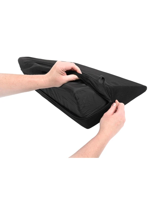 Black wedge pillow with hands unzipping the cover.