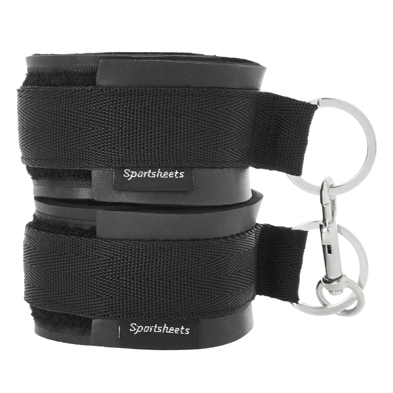 Black adjustable neoprene cuffs with metal rings and clasps.