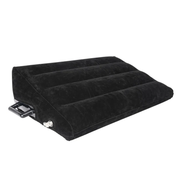 Black inflatable wedge pillow with velvet texture and handles.