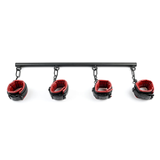 Black spreader bar with four red and black faux leather cuffs.