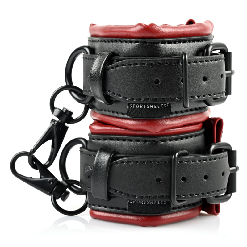 Black and red faux leather cuffs with metal clips and buckles.