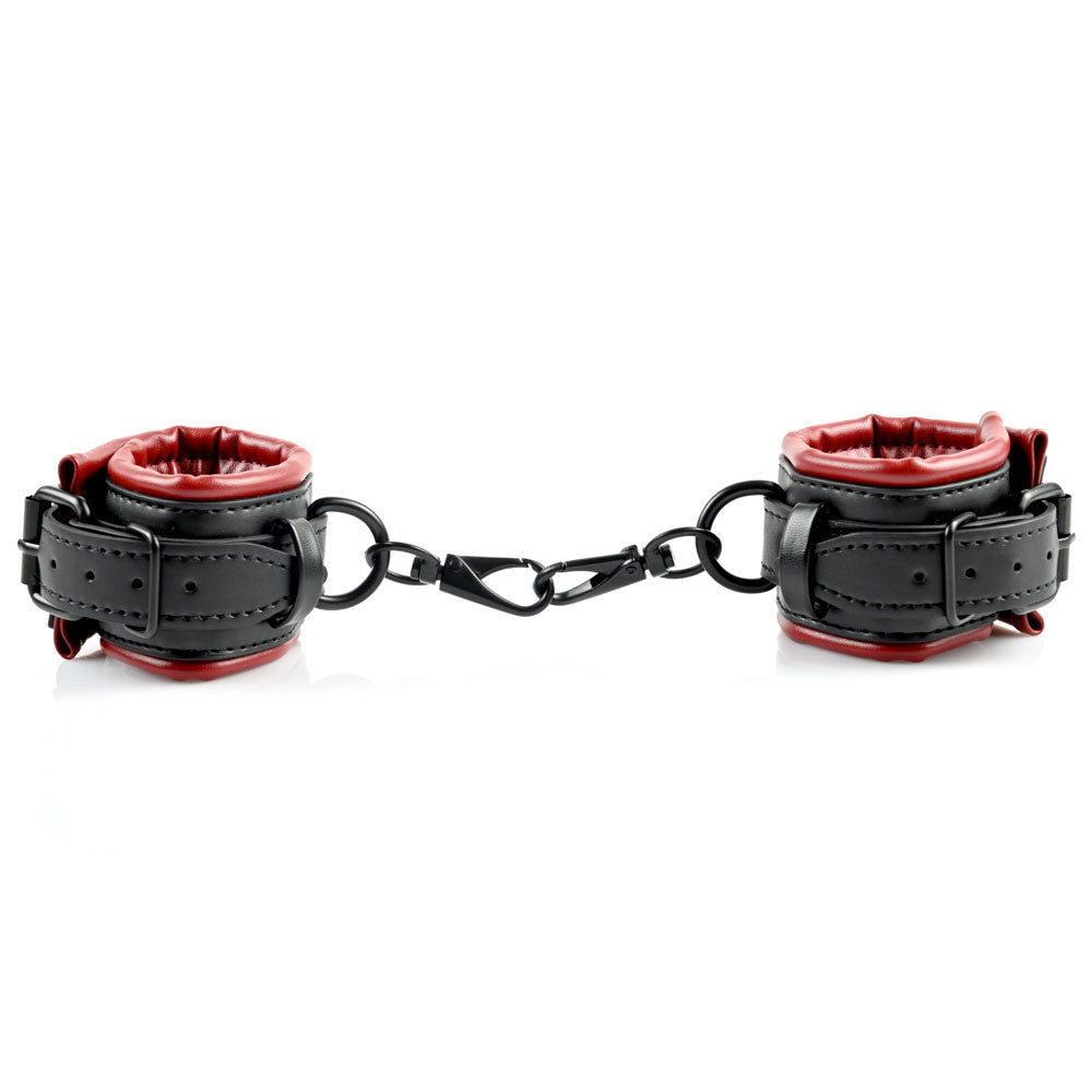 Black and red faux leather cuffs connected by a metal chain.