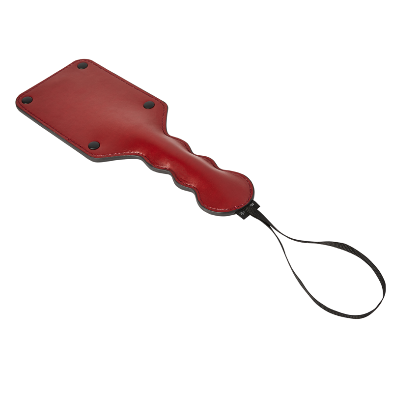 Red vegan leather square paddle with a wavy handle and wrist strap.