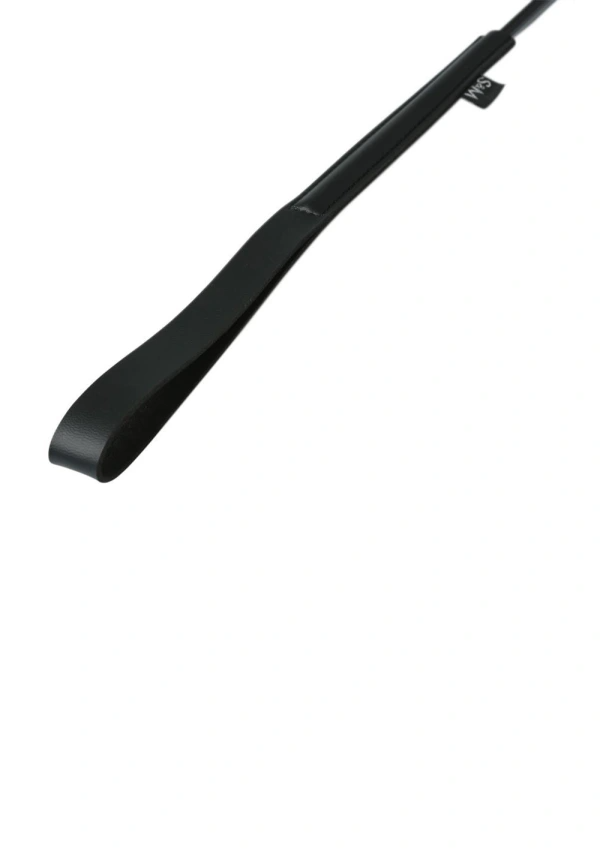 Black spanking wand with a wrist strap and a small tag.