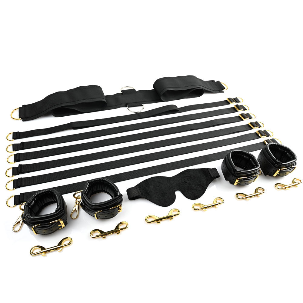 Restraint set with faux leather cuffs, blindfold, and straps with gold hardware.