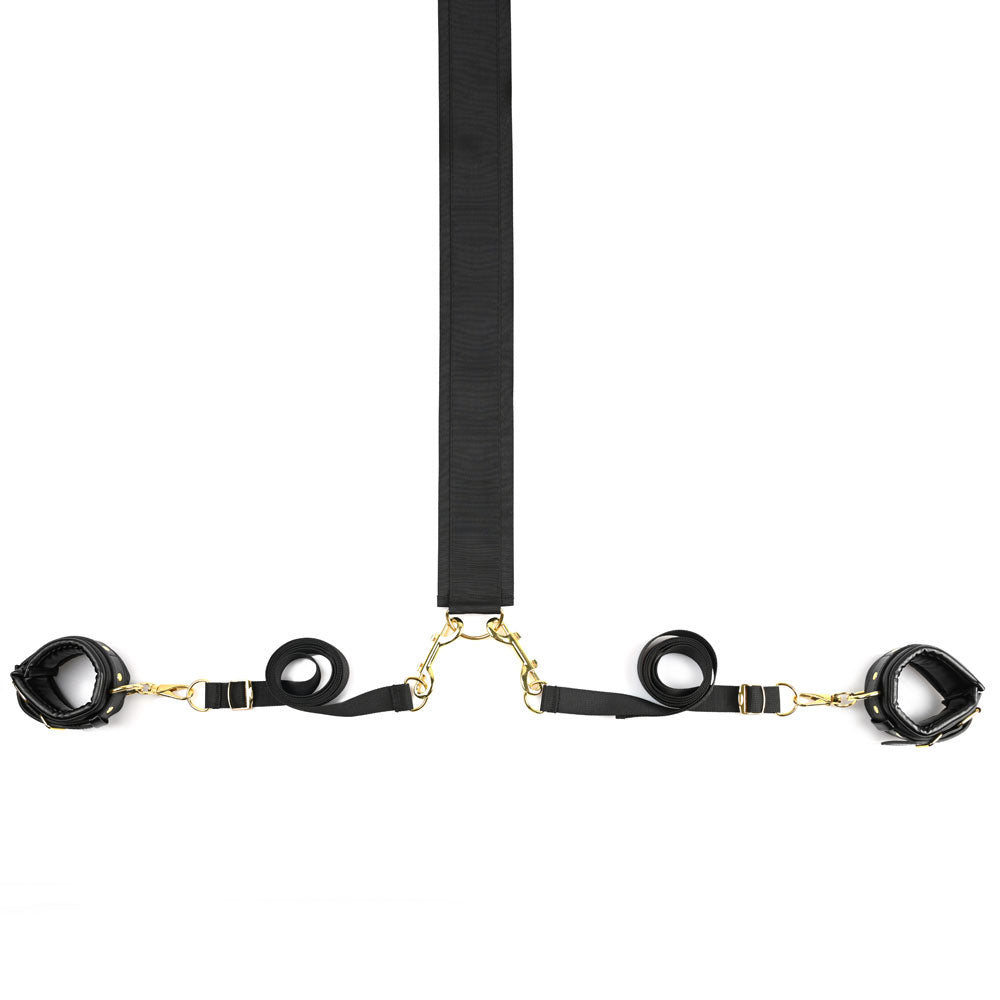 Black restraint set with faux leather cuffs and gold hardware.