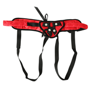 Red lace harness with black straps and a metal O-ring.