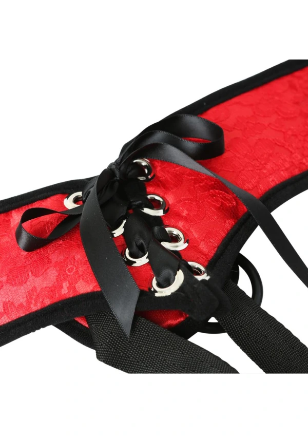 Red lace corset strap-on harness with black ribbon lacing and silver grommets.