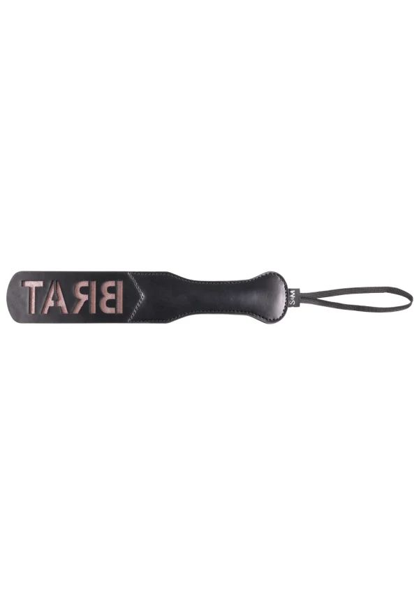 Black faux leather spanking paddle with "BRAT" cut out in rose gold.