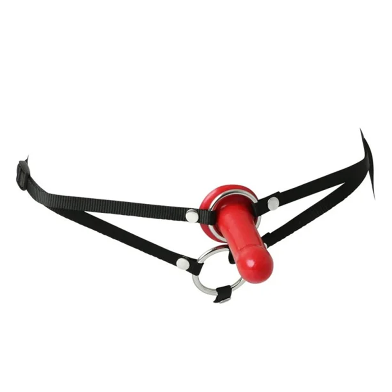 Red dildo with black strap-on harness and metal rings.