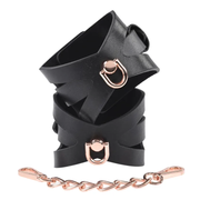 Black faux leather handcuffs with rose gold hardware and chain.