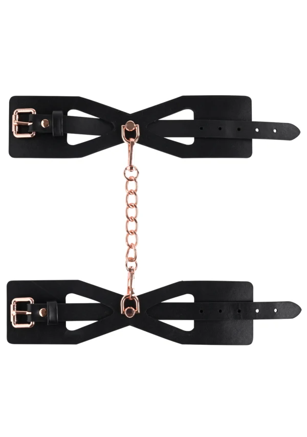 Black faux leather handcuffs with rose gold chain and buckles.