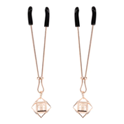 Rose gold adjustable nipple clips with pearl accents.
