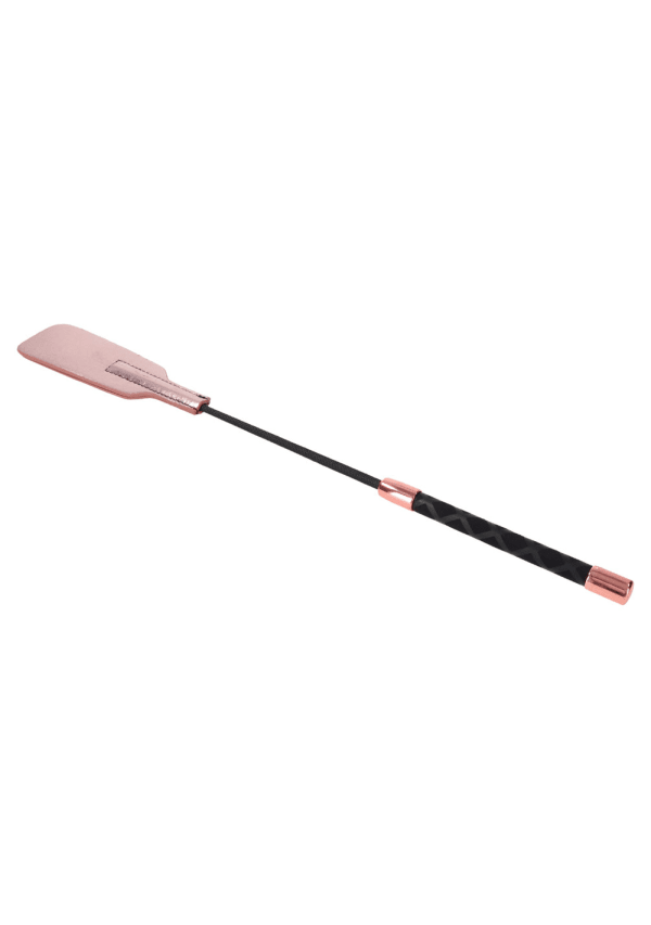 Rose gold vegan leather crop whip with a black textured handle.
