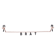Rose gold chain nipple clamps with black "BRAT" lettering.