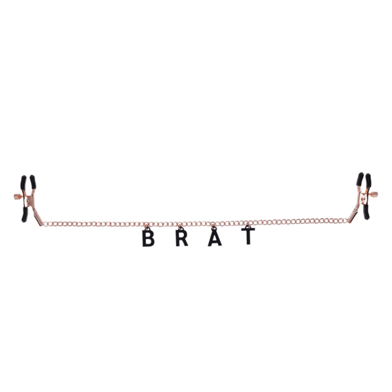 Rose gold chain nipple clamps with black "BRAT" lettering.