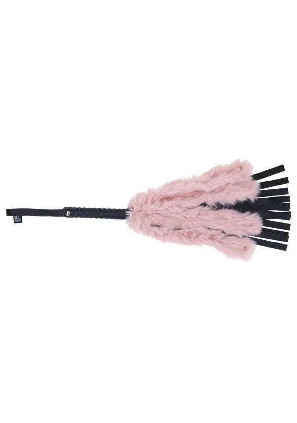 A pink faux fur flogger with black vegan leather falls and a black handle.