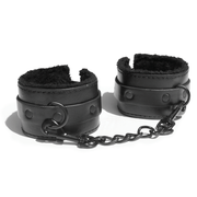 Black faux fur lined vegan leather handcuffs with a metal chain.