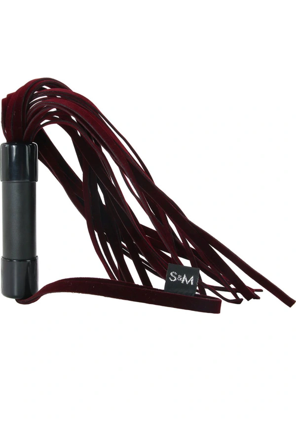 Red velveteen flogger with black handle and wrist loop.