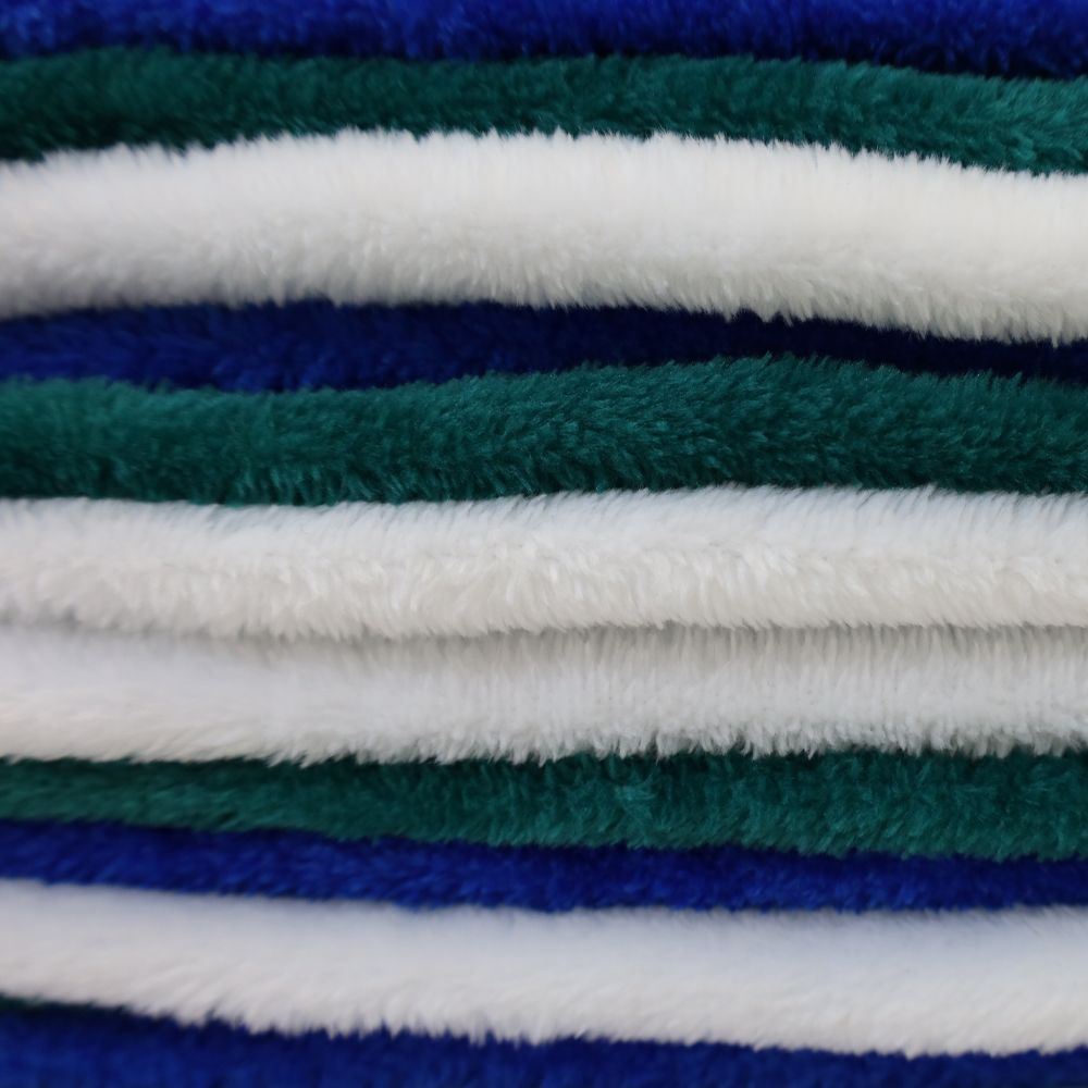 Stacked plush fleece blankets in blue, green, and white stripes.