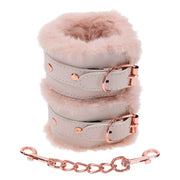 Peach faux fur handcuffs with rose gold hardware and chain.