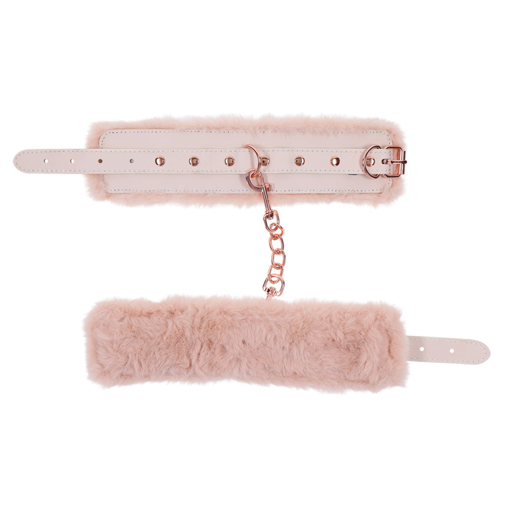 Peach faux fur handcuffs with rose gold hardware and chain.