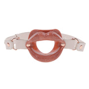 Silicone lip gag with faux leather strap.