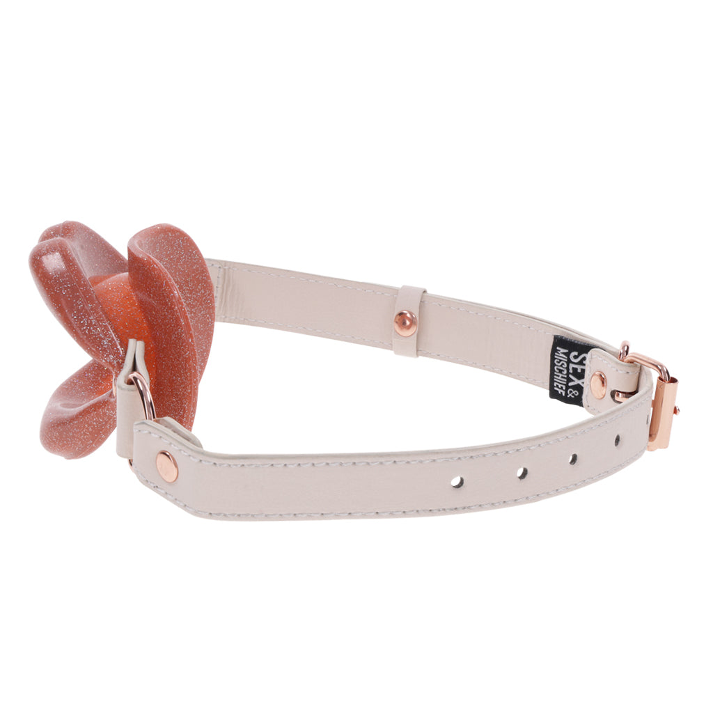 Silicone lip gag with faux leather strap.