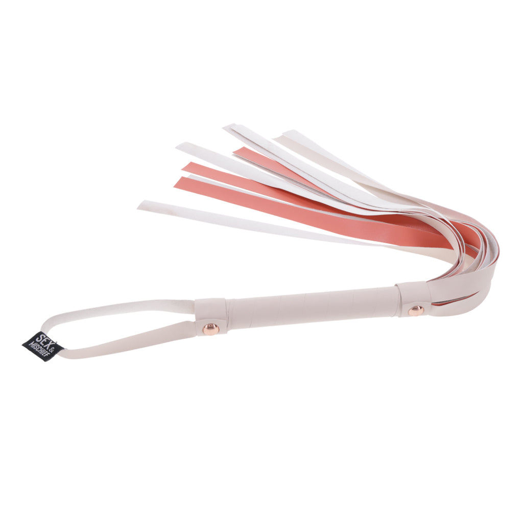 Faux leather flogger with white and peach falls and rose gold accents.