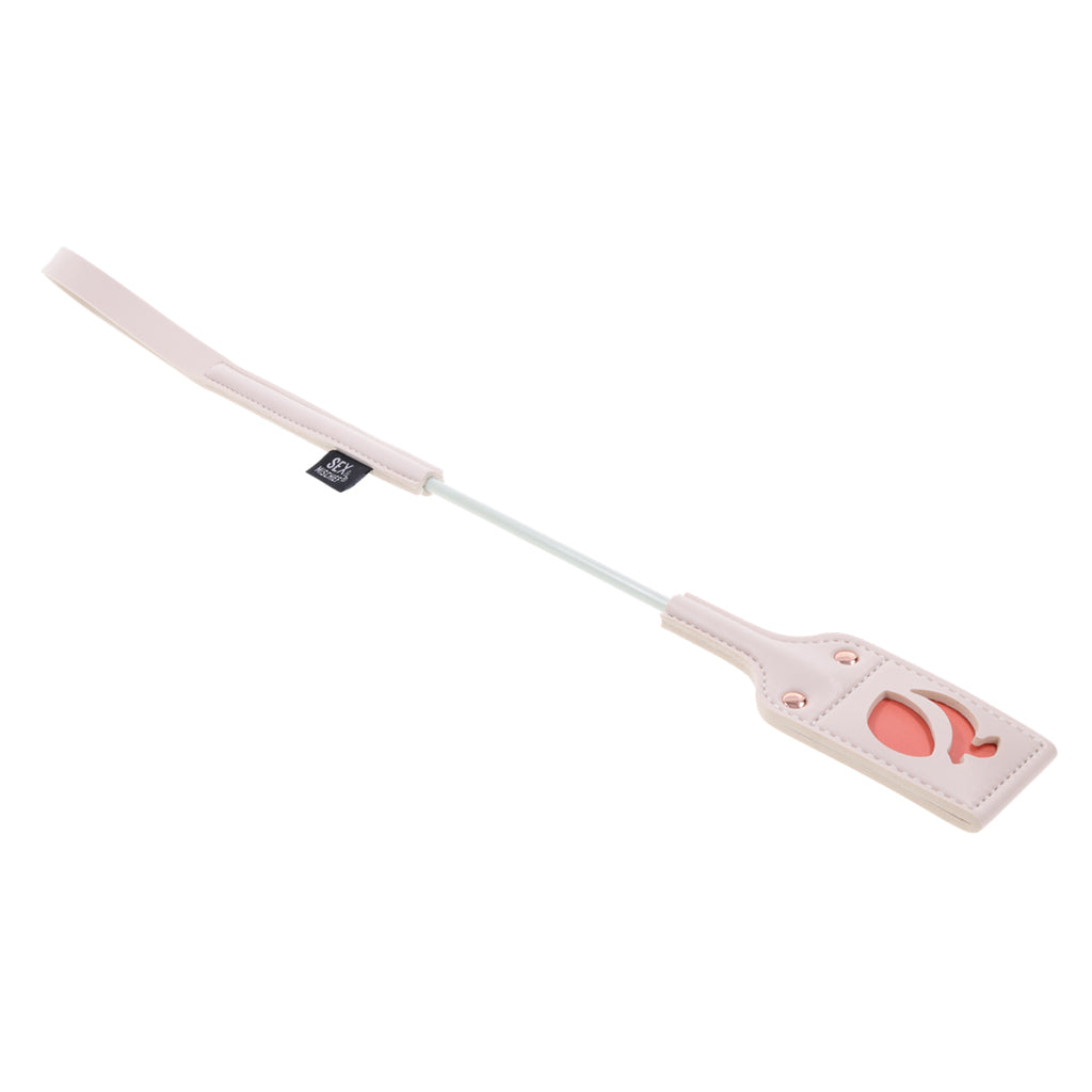 A pink faux leather riding crop with a peach cutout on the tip.