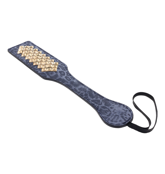 Blue leopard print faux leather paddle with gold studs and a wrist loop.