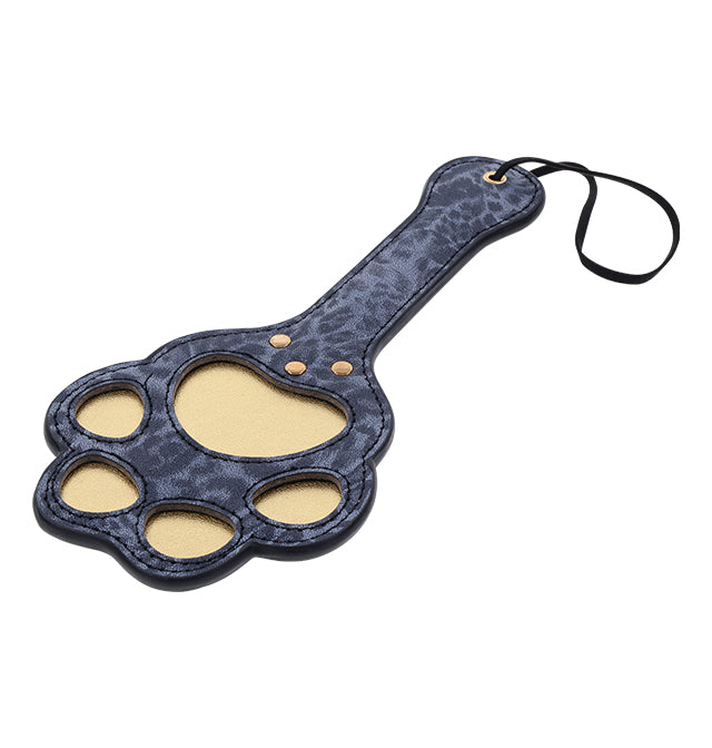 A blue leopard print faux leather paddle shaped like a cougar paw with cutouts and a wrist loop.