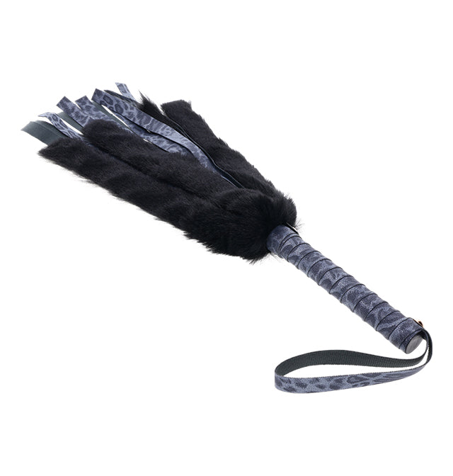 Black faux fur flogger with navy blue leopard print leather accents and handle.