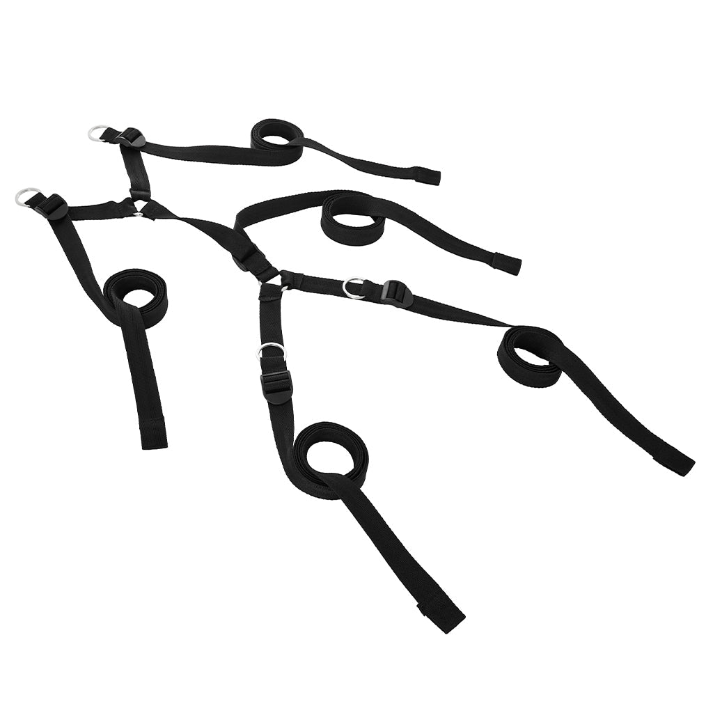Black adjustable restraint system with four cuffs and metal rings.