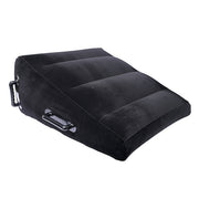 Black inflatable wedge positioner with velvet cover and handles.