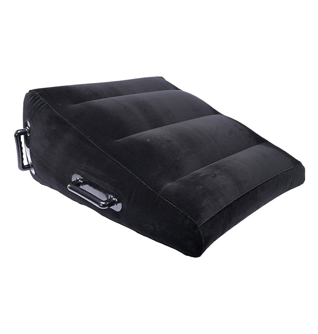Black inflatable wedge positioner with velvet cover and handles.