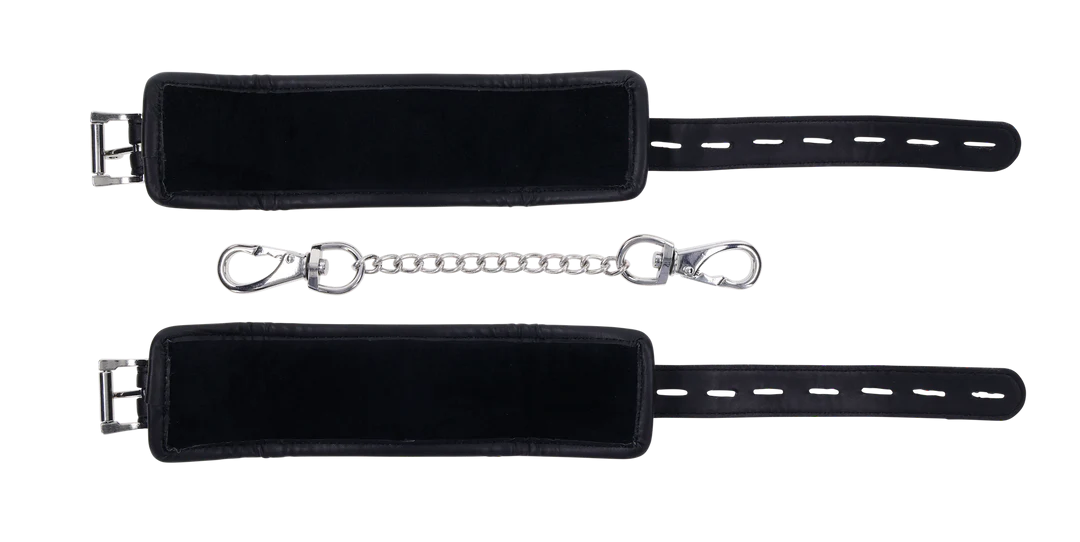 Black padded adjustable cuffs with a metal chain tether.