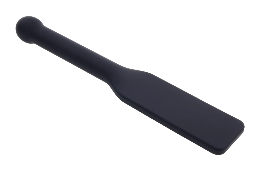 Dark gray silicone paddle with a rounded handle and flat striking surface.