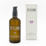Intamo plant-based intimate massage oil in a brown bottle with a pump.