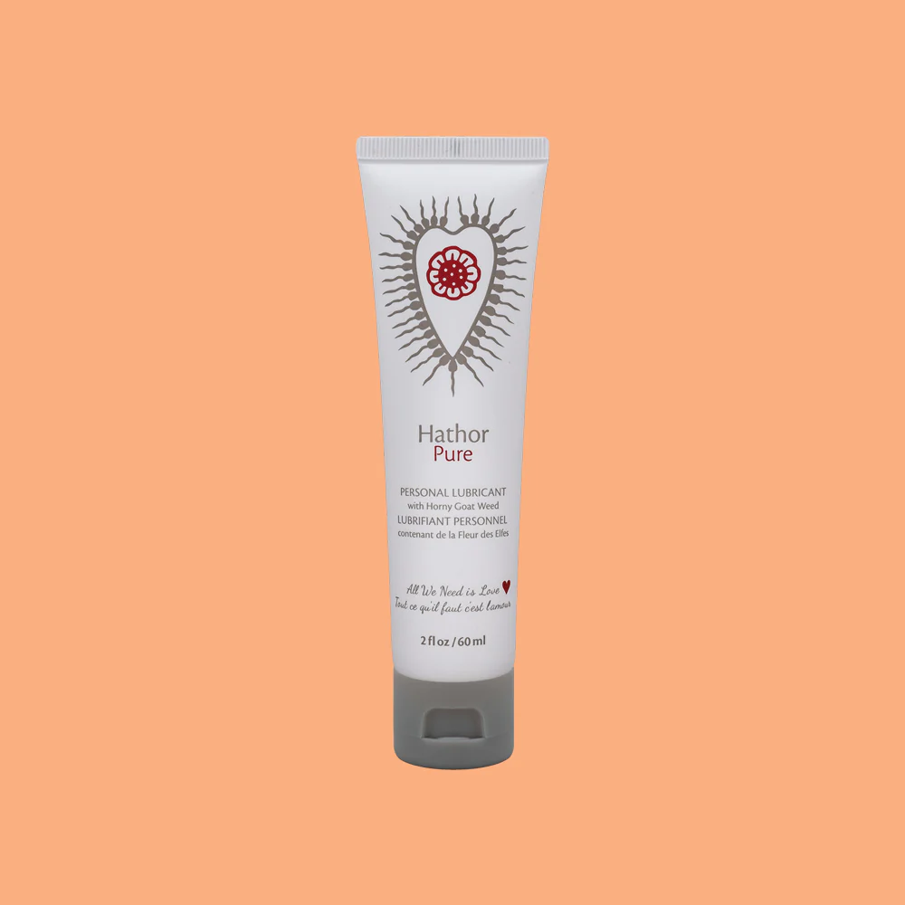 Hathor Pure personal lubricant in a white tube with a red heart design.