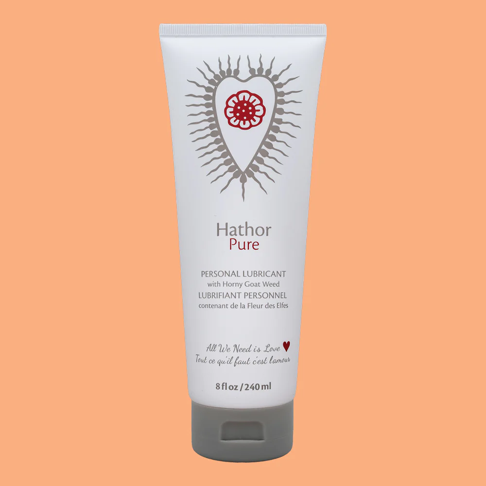 Hathor Pure personal lubricant in a white tube with a red floral heart design.