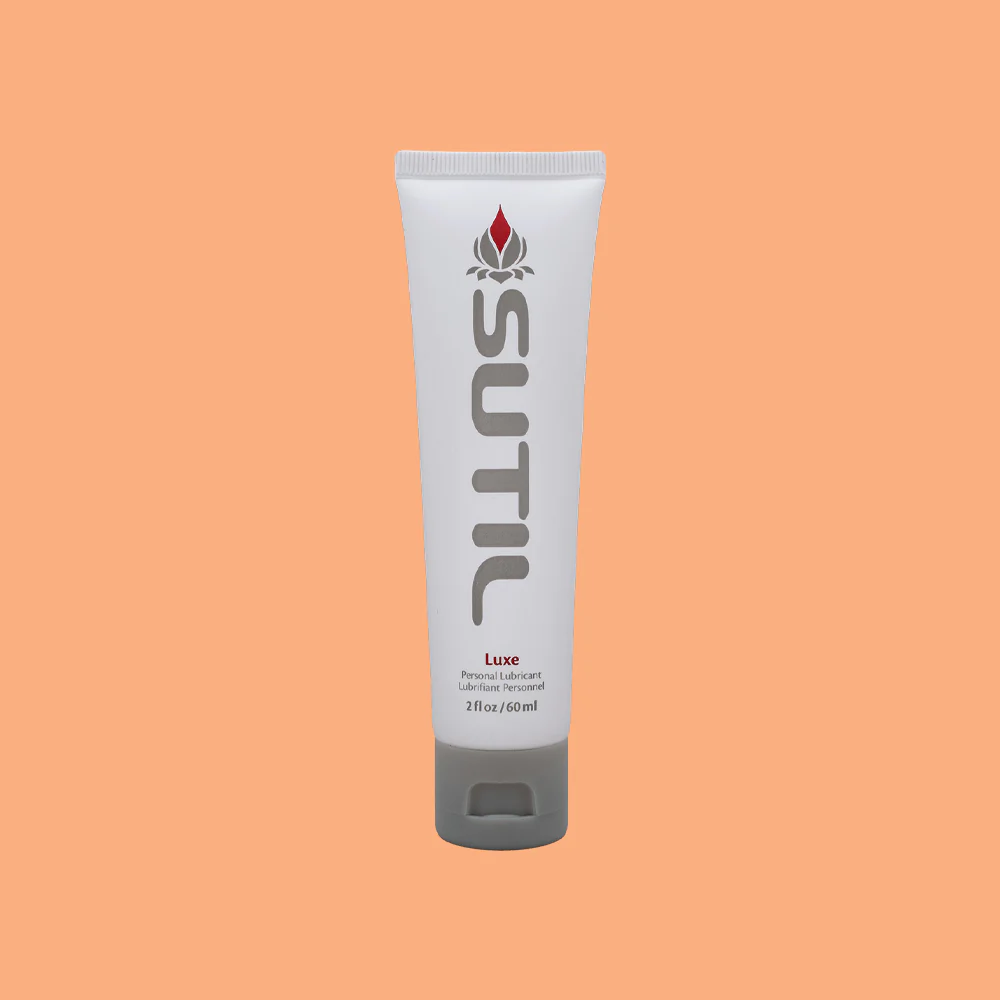 A white tube of Sutil Luxe personal lubricant with a grey cap.