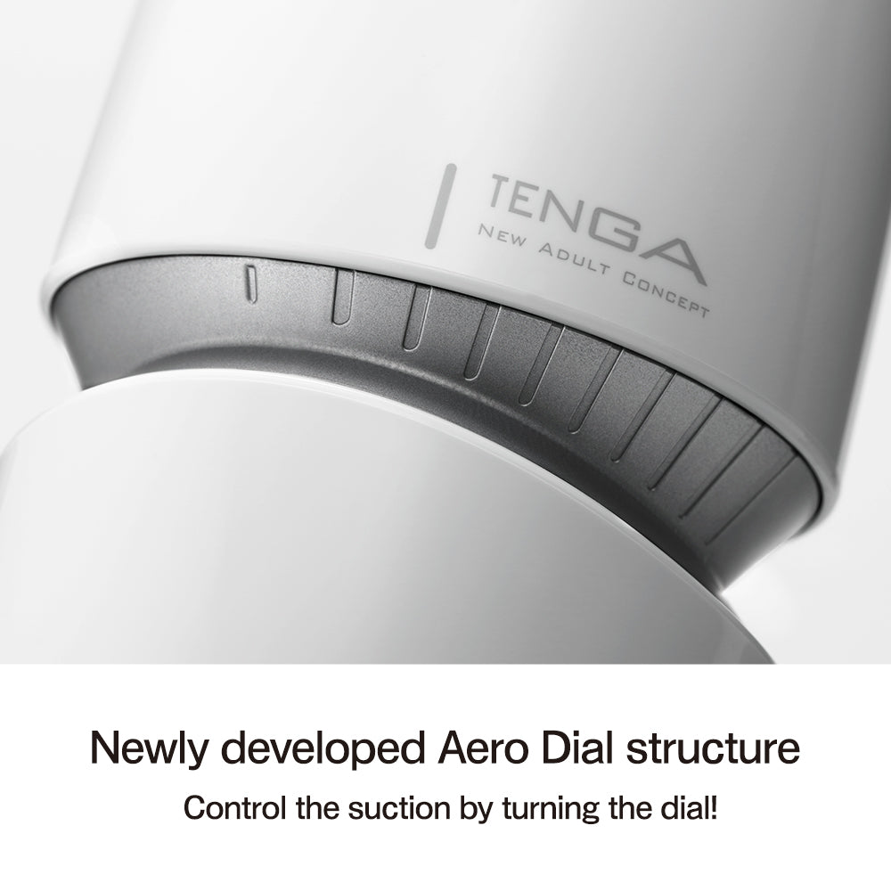Close-up of a white Tenga masturbator with a gray dial and the Tenga logo.