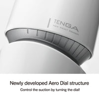 Close-up of a white Tenga masturbator with a gray dial and the Tenga logo.
