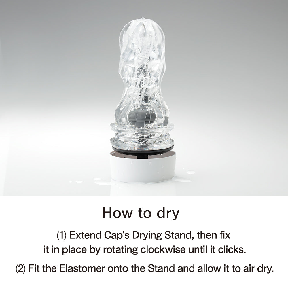 A clear textured masturbator with a white drying stand.