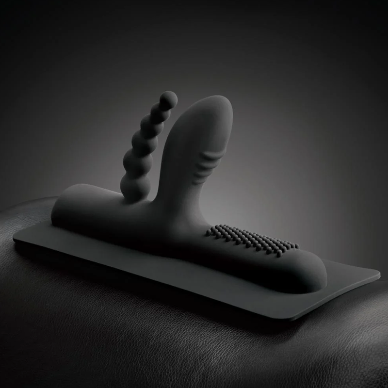 Black silicone attachment with anal beads and a studded surface.