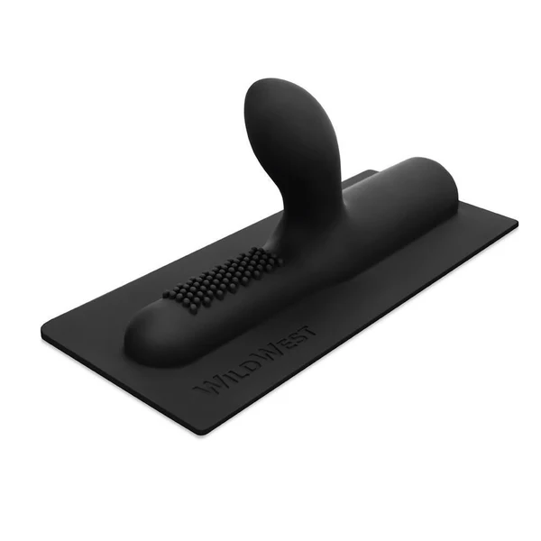 Black ribbed silicone attachment with studs on a flat base.