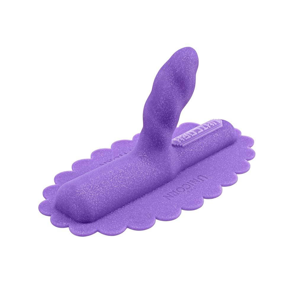 A purple glittery silicone attachment with a scalloped base and a curved tip.