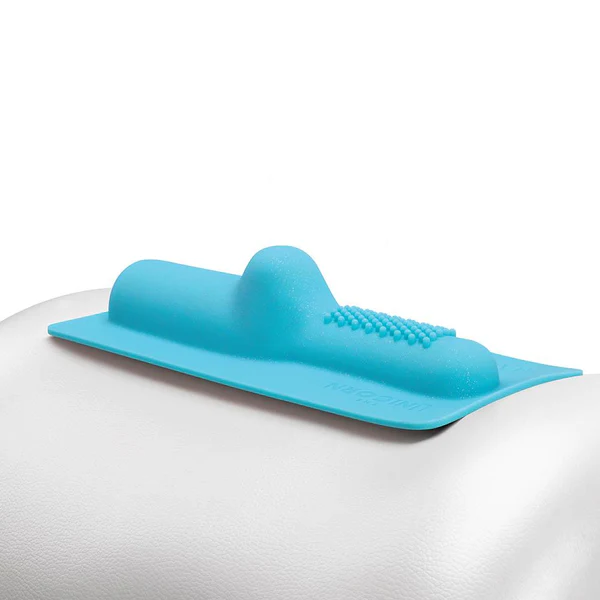 A blue silicone attachment with a raised bumpy section rests on a white surface.